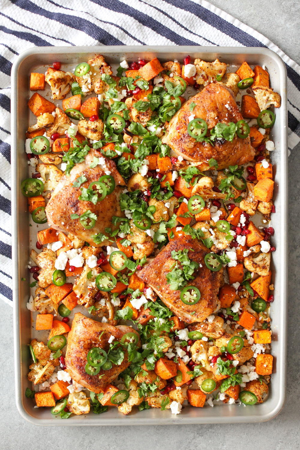 Sheet Pan Chicken Thighs with Cauliflower, Sweet Potatoes, and Pomegranate